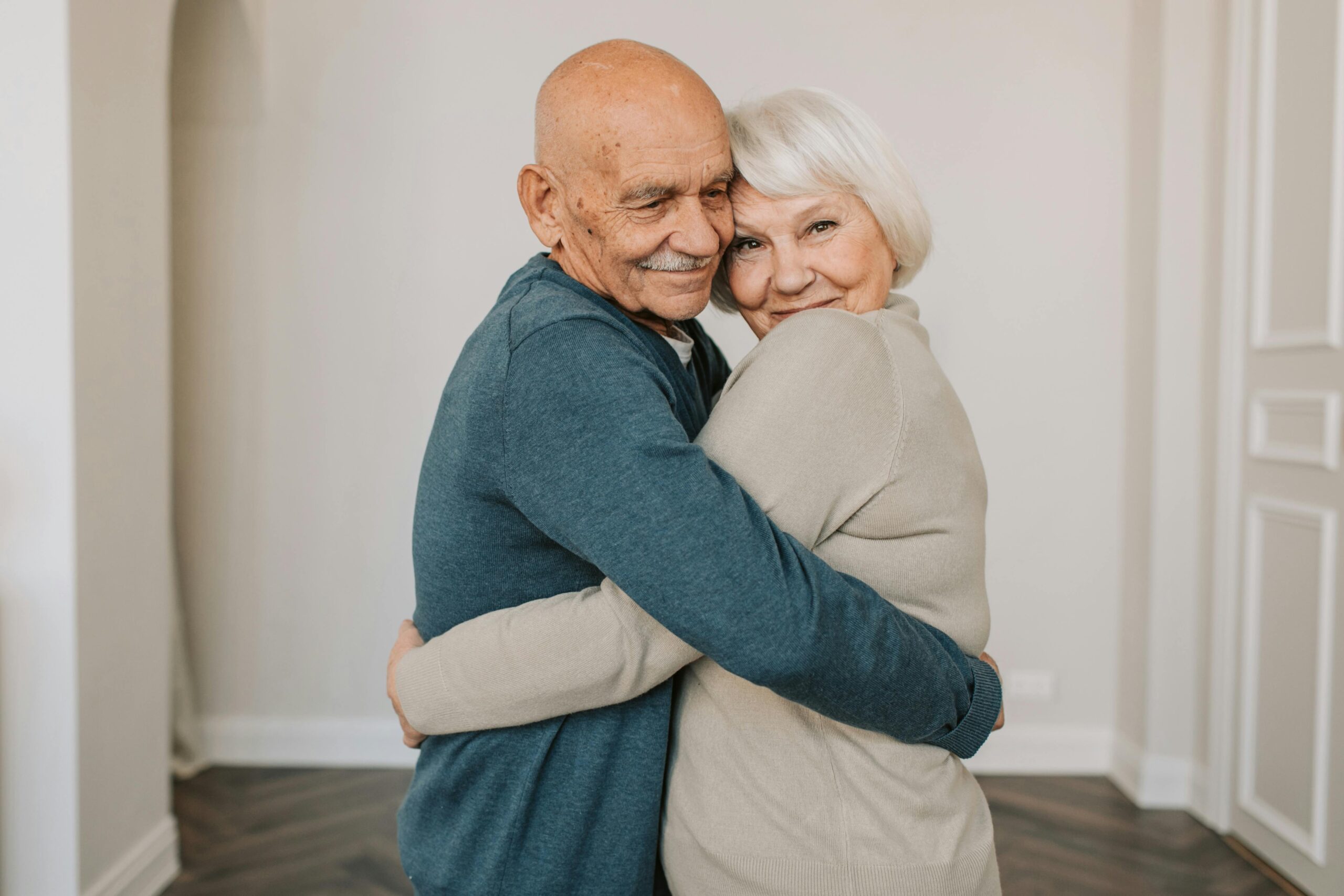 two seniors hugging